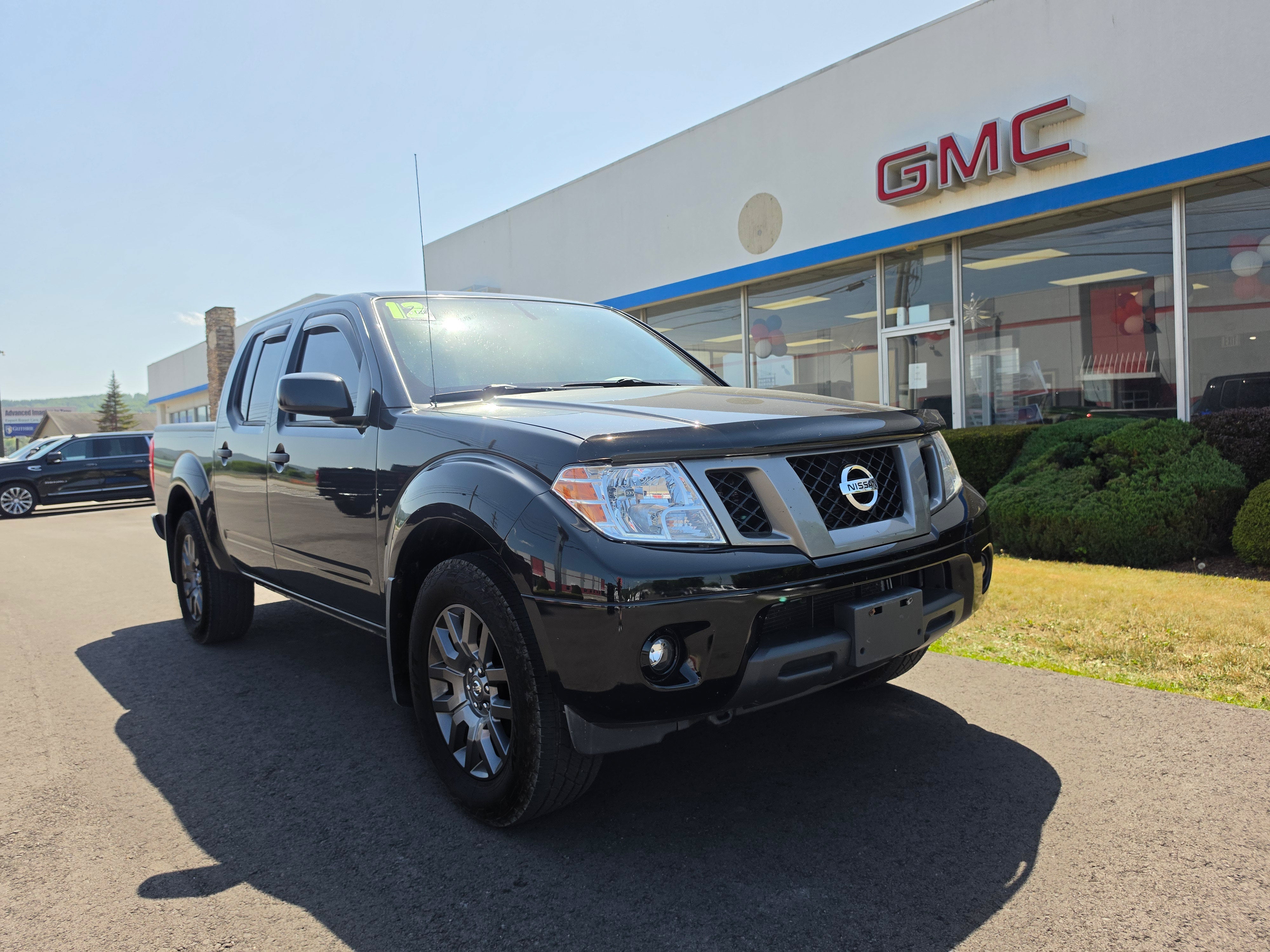 2012 Nissan Frontier SV in Super Black — front three-quarter view