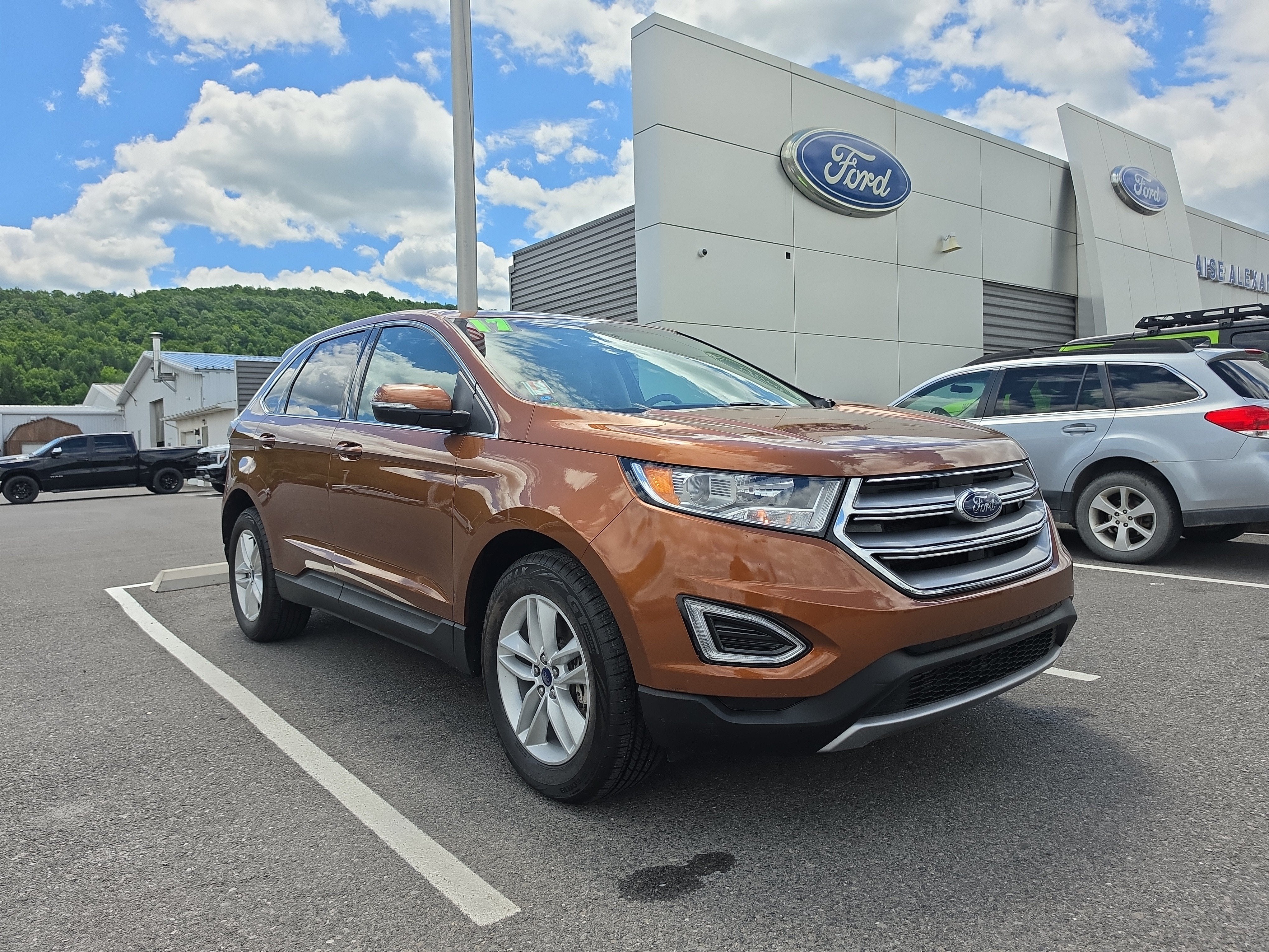 2017 Ford Edge SEL in Canyon Ridge Metallic — front three-quarter view